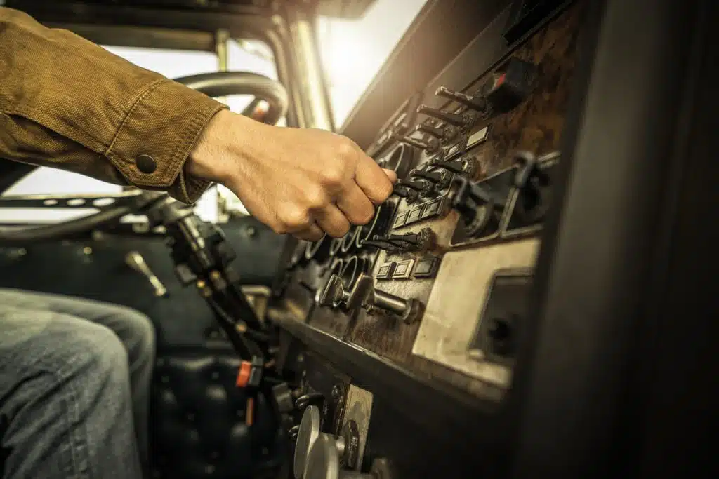 Truck driver switching dashboard buttons
